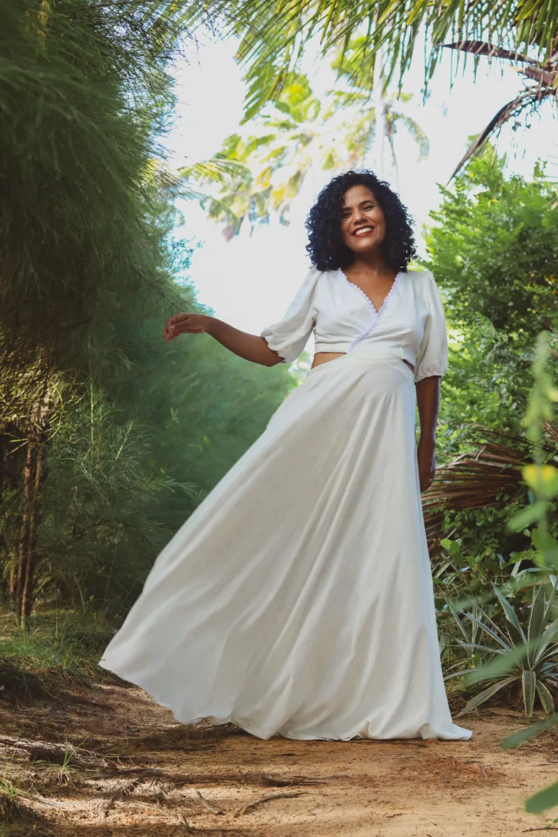 Mulher com vestido branco em cenário natural